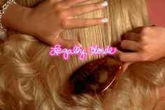 a woman is combing her blonde hair with the words legally blonde written on it