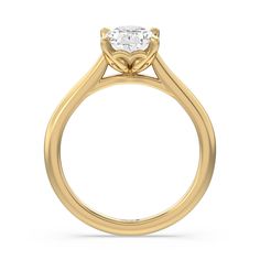 a yellow gold engagement ring with a round diamond in the center, on a white background