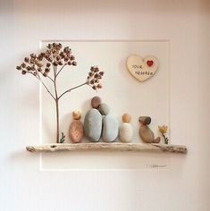 some rocks are sitting on a shelf with a tree