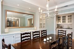 a dining room table with chairs and a chandelier