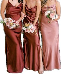 three women in long dresses standing next to each other with flowers on their bouquets