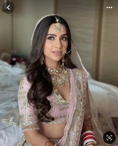 a woman in a bridal outfit sitting on a bed