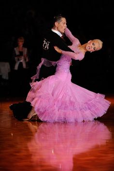 a man and woman dancing on a dance floor