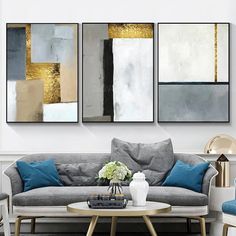 a living room with three paintings on the wall