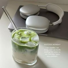 there is a drink with ice in it and headphones on the table