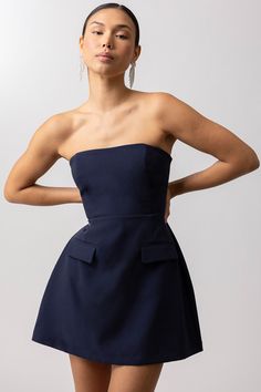 Our Paris Mini Dress is a structured, navy blue, strapless mini dress designed for the lover of all things chic. This structured dress creates a feminine silhouette and will last in your closet for years to come. size recommendations: runs large, size down one size. zipper closure up the back. no stretch extra small (0-2) small (4) medium (6-8) large (10-12) Structured Mini Dress, Structured Dress, Line Dot, Top Skirt Set, Swimwear Sets, Feminine Silhouette, Top Pants Set, Strapless Tops, Strapless Mini Dress