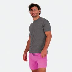 a man in grey shirt and pink shorts