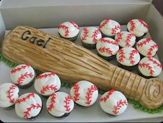 cupcakes and a baseball bat in a box with the word gad on it