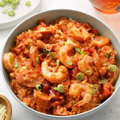 a bowl filled with shrimp and rice on top of a table