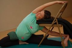 a woman sitting on a chair doing yoga