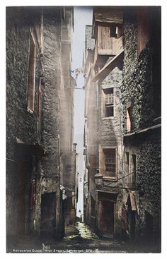 an old narrow street with stone buildings on both sides