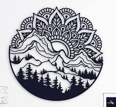 a circular cutout with trees and mountains in the background, on a white wall