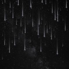 the night sky is filled with stars and falling down on it's black surface