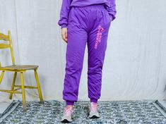 "AUNT GERTRUDE PRESENTS - vintage 90's purple tracksuit - brand: Skis Dynastar - lined, insulated - material: 100% cotton CONDITION (1-10 ❶❷❸❹❺❻❼❽ Good vintage condition SIZE/MEASUREMENTS size from label: XL TOP chest: 52 inches (132 cm) length: 23,5 inches (60 cm) sleeve length from armpit: 18 inches (46 cm) PANTS waist: 33-40 inches (84-102 cm) elastic waist hips: 44 inches (112 cm) rise: 12 inches (31 cm) length: 40 inches (101 cm) inseam: 30 inches (76 cm) The model is 5'9\" (174 cm), measur Winter Athleisure Tracksuit With Elastic Waistband, Athleisure Tracksuit With Elastic Waistband For Winter, Winter Tracksuit With Elastic Waistband And Relaxed Fit, Winter Workout Cotton Tracksuit, Winter Jogging Tracksuit With Elastic Waistband, Winter Tracksuit With Elastic Waistband For Jogging, Fitted Joggers For Streetwear, Relaxed Fit Tracksuit With Elastic Waistband For Sports, Sporty Purple Cotton Sweats