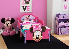 a minnie mouse bedroom with pink walls and furniture