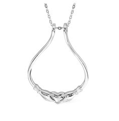 a silver necklace with an intricate design on the front and back end, hanging from a chain