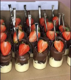 chocolate covered strawberries are arranged in small cups