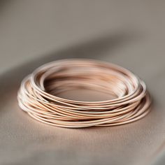 Chic Everyday Rose Gold Bracelet, Chic Rose Gold Bangle Bracelet, Elegant Stackable Bangle Wrap Bracelet, Minimalist Rose Gold Bangle Jewelry, Everyday Stackable Wrap Bangle Bracelet, Minimalist Rose Gold Bangle, Delicate Stackable Rose Gold Bracelets, Adjustable Rose Gold Bangle For Everyday, Minimalist Stackable Rose Gold Bracelets