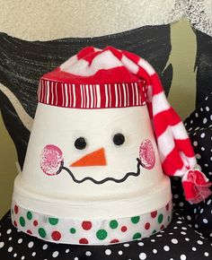 a snowman hat sitting on top of a polka dot pillow