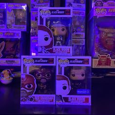 several pop vinyls are on display in the dark