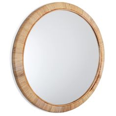 a round wooden mirror hanging on the wall above it's reflection, in front of a white background