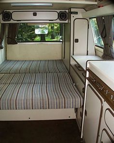 the interior of a camper van is clean and ready for people to use it