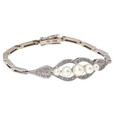 Bracelet made of white 14-karat gold. Beautifully decorated with five white cultured pearls surrounded by 30 diamonds in an 8/8 cut weighing approx. 0.18ct. Bracelet closed with a clasp with an additional safety eight. Origin: Western Europe, second half of the 20th century. Length: 15.5cm Weight of the product: 11.70g. Very good condition, no damage We include a certificate from a diamond and pearl appraiser with the purchase. A beautiful, delicate proposition for a lover of classic pearl jewelry. Classic Pearl Jewelry, Antique Gold Bracelet, Bracelet Pearls, Bracelet With Pearls, Retro Bracelet, Pearl Jewels, Pearl Bracelets, Modern Bracelets, Gold Jewelry Sets