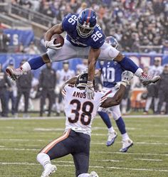 two football players jumping in the air during a game