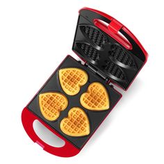 a waffle maker with four heart shaped waffles in the front and on the back