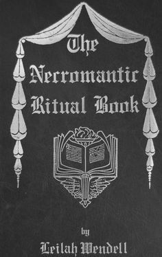 an old black book with white writing on the front and back cover, which is decorated with