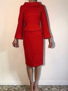 Wow! Amazing Thierry Mugler red wool jacket and skirt set. As always these Mugler pieces have been made impeccably - such craftsmanship! Mugler is always sewn and patterned with the most care. Love this amazing saturated intense red. The fabric is a fine wool suiting. The fabulous Mugler style can be seen with the great folded over boat neck collar and asymmetrical front closure. Hidden metal silver snaps up the asymmetrical closure. Raglan sleeve with trumpet shape. Crisp curved shoulder - no s Tailored Red Skirt Suit For Office, Elegant Red Skirt Suit For Fall, Red Long-sleeve Skirt Suit For Party, Red Long Sleeve Skirt Suit For Party, Elegant Red Fitted Skirt Suit, Tailored Red Long Sleeve Skirt Suit, Classic Red Skirt Suit For Work, Red Long-sleeve Skirt Suit For Office, Red Long Sleeve Skirt Suit For Work