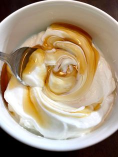 a bowl filled with whipped cream and caramel sauce