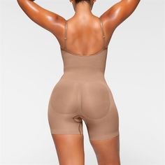 The sculpting bodysuit all over your feed, updated for an even better fit. Wear this mid thigh bodysuit for strong compression and targeted control along the waist, tummy, and legs, plus butt-enhancing pockets for a lifted look. Features front pique stitching along the front and sides for a defined and supported bust, adjustable straps, a wide crotch for added coverage, and a cotton gusset. Fits true to size. | SKIMS Mid Thigh Bodysuit | Medium Neutral | Seamless Sculpt Seamless Stretch Shapewear, Mid-thigh Length, Seamless Second-skin Shapewear With Full Coverage, Seamless High-cut Leg Shapewear In Elastane, Seamless Compression Shapewear, Mid-thigh Length, Beige Micro-elastic Seamless Shapewear, Multi Dress, Shapewear Bodysuit, Custom Size Dresses, Cute Lazy Day Outfits