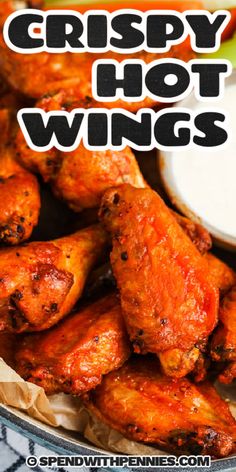 crispy hot wings with ranch dressing in the background and text overlay that reads crispy hot wings