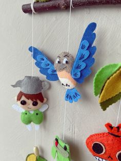 several stuffed animals hanging from strings on a wall