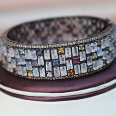 One (1) Pc Pave Diamond Excellent Designer Rainbow Moonstone & Multi Sapphire Bangle Bracelet - 925 Sterling Silver -Bangle With Lock BD077 Approx Measurement: Size: 2.4+inches Diameters (inside) Diamond Wt: 3.25 cts Silver Purity: 925 Metal: Sterling Silver Finish : Oxidized Gemstone : Rainbow moonstone , Multi Sapphire Sold As: 1 Pc We are continuously adding new products in our store. So keep coming back to see more great deals on gems in our mart. Amazing quality at the best price around Silver Bangle With Stones For Gift, Silver Bangle With Stones As A Gift, Cubic Zirconia Multi-stone Bangle, Luxury Multi-stone Bangle For Gift, Luxury Multi-stone Bangle As Gift, Multi-stone Cubic Zirconia Bangle, Silver Fusion Bangle With Gemstone, Sterling Silver Bangle Bracelet With Natural Stones, White Gemstone Bangle Jewelry