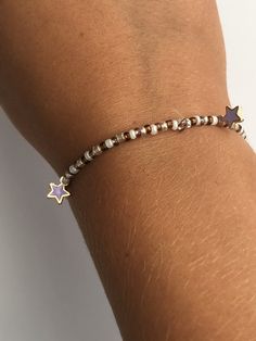 A beaded bracelet with star charms but you can pick what color stars you would like Adjustable Star Charm Bracelet, Adjustable Stretch Bracelet With Star Charm As Gift, Adjustable Bracelets With Star Charm, Adjustable Bracelets With Star Charm And Round Beads, Adjustable Beaded Bracelets With Star Charm For Gift, Beaded Bracelets With Star Charm For Gifts, Trendy Star-shaped Beaded Jewelry, Gold Bracelets With Star Charm And Round Beads, Trendy Star Shaped Beaded Jewelry