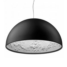 a black and white light hanging from a ceiling fixture with an intricate pattern on it