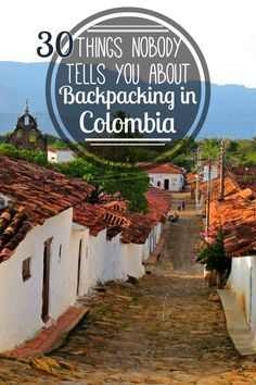 a cobblestone road with the words 30 things nobody tells you about backpacking in colombia