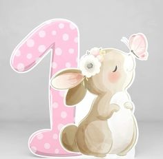 a pink and white number one with a bunny holding a flower in it's hand