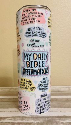 a can with writing on it sitting on top of a wooden table next to a wall