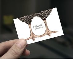 a person holding up a business card with two birds on it