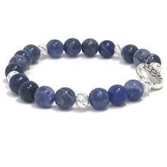 Sodalite gemstones bracelet. Sodalite emits an easy, tranquil energy that clears the mind and elicits deep thought, expanding the ability to arrive at logical conclusions based on rational consideration. It enhances one’s powers of analysis, intuition, observation and creativity, and strengthens self-discipline, efficiency and organization Highlights;- 8mm high quality sodalite beads- Silver plated Lotus Charm- 6mm silver plated metal beads**Due to the nature of the natural stones, all stones wi Spiritual Sapphire Beaded Bracelets With Natural Stones, Silver Lapis Lazuli Beaded Bracelets For Healing, Spiritual Lapis Lazuli Crystal Bracelet For Healing, Blue Spiritual Stretch Bracelet, Spiritual Blue Stretch Bracelet, Blue Spiritual Stretch Bracelet For Everyday, Spiritual Blue Bracelets For Everyday, Spiritual Blue Bracelet For Everyday, Deep Thought