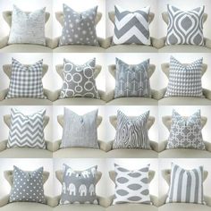 many different types of pillows on a white couch with grey and white designs in the middle