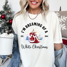 I'm dreaming of a white christmas Shirt, White Christmas T-Shirt, Christmas Movie Tee, A White Christmas Tee, Gift Christmas Song Tee Welcome to SalihasGiftShop! **Product Overview  Our t-shirts are designed for both comfort and style, perfect for football lovers and trendsetters alike. We proudly use high-quality Bella Canvas and Gildan SoftStyle shirts for all of our prints, ensuring maximum comfort and durability. Bella Canvas: Lightweight (4.2 oz), unisex sizing, and available in a variety of fabric options including 100% Combed Cotton, Ring-Spun Cotton, and Polyester blends. Gildan SoftStyle: Unisex sizing, with choices ranging from Ring-Spun Cotton, Polyester blends, and 100% Ring-Spun Cotton for a perfect fit and soft feel. Each t-shirt is printed using advanced DTF (Direct to Film) I'm Dreaming Of A White Christmas Sign, White Christmas Graphic Tee, Casual White Christmas T-shirt, White Relaxed Fit T-shirt For Christmas, White Christmas Festive T-shirt, Dreaming Of A White Christmas, Movie Tees, A White Christmas, Football Lovers