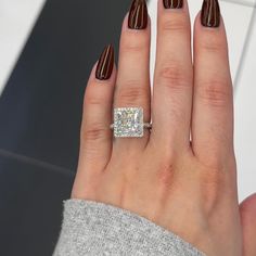 a woman's hand with a diamond ring on it