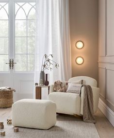 a living room filled with furniture and decor on top of a hard wood floored floor