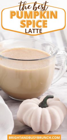 the best pumpkin spice latte in a glass bowl on a marble surface with white pumpkins