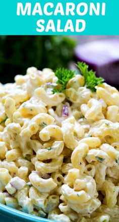 macaroni salad in a blue bowl with parsley on top and text overlay