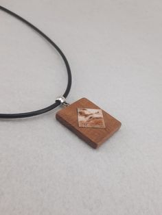 Made from Alder wood. Carved from a beautiful piece of maple wood, with stone inlay. All of our products are made from sustainably sourced wood and/or reclaimed wood. All pieces are made one by one, entirely by hand. Approximate pendant size: 35 x 28 mm (0.14 in x 0.11 in) CORD Approximate lanyard length - 46.5 cm (18.3 in.) ------------------------------------------------------------------------------------------------------------------- PLEASE, READ THE SHIPPING & POLICIES INFORMATIONS BEFORE Natural Wood Pendant Necklace, Wooden Necklace, Alder Wood, Stone Inlay, Wood Necklace, Wooden Pendant, Wood Carved, Nature Jewelry, Wooden Jewelry